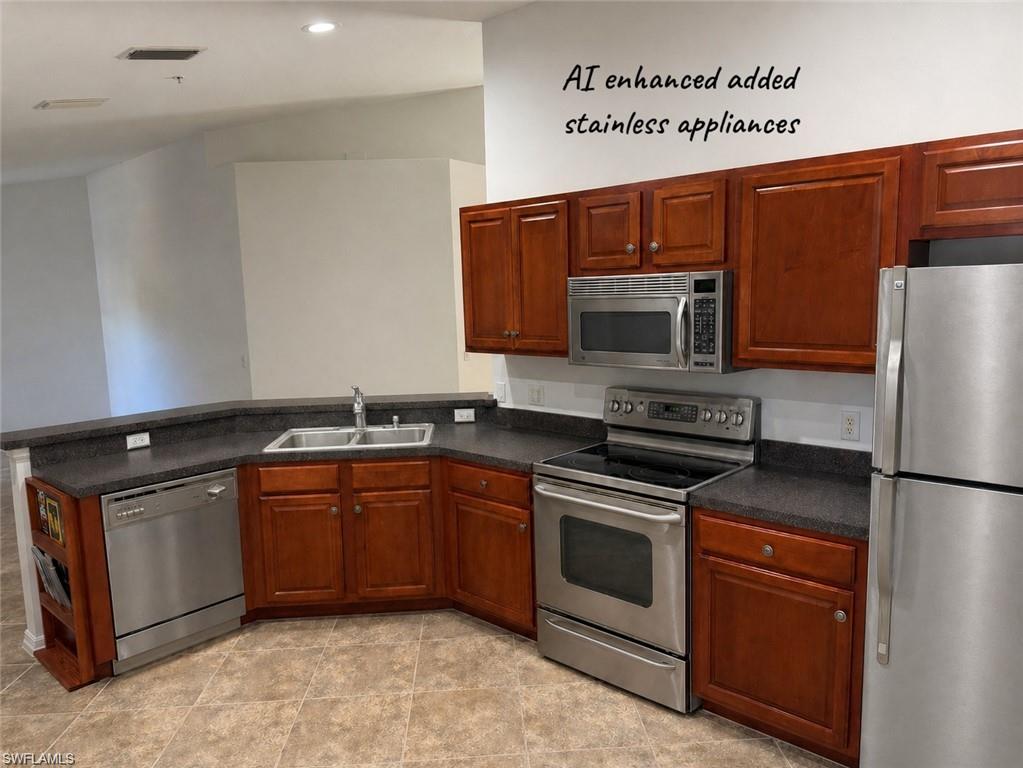 1345 Henley Street, Unit 705 Naples, FL 34105 - Photo 9 of 26 a kitchen with stainless steel appliances granite countertop a stove microwave and refrigerator