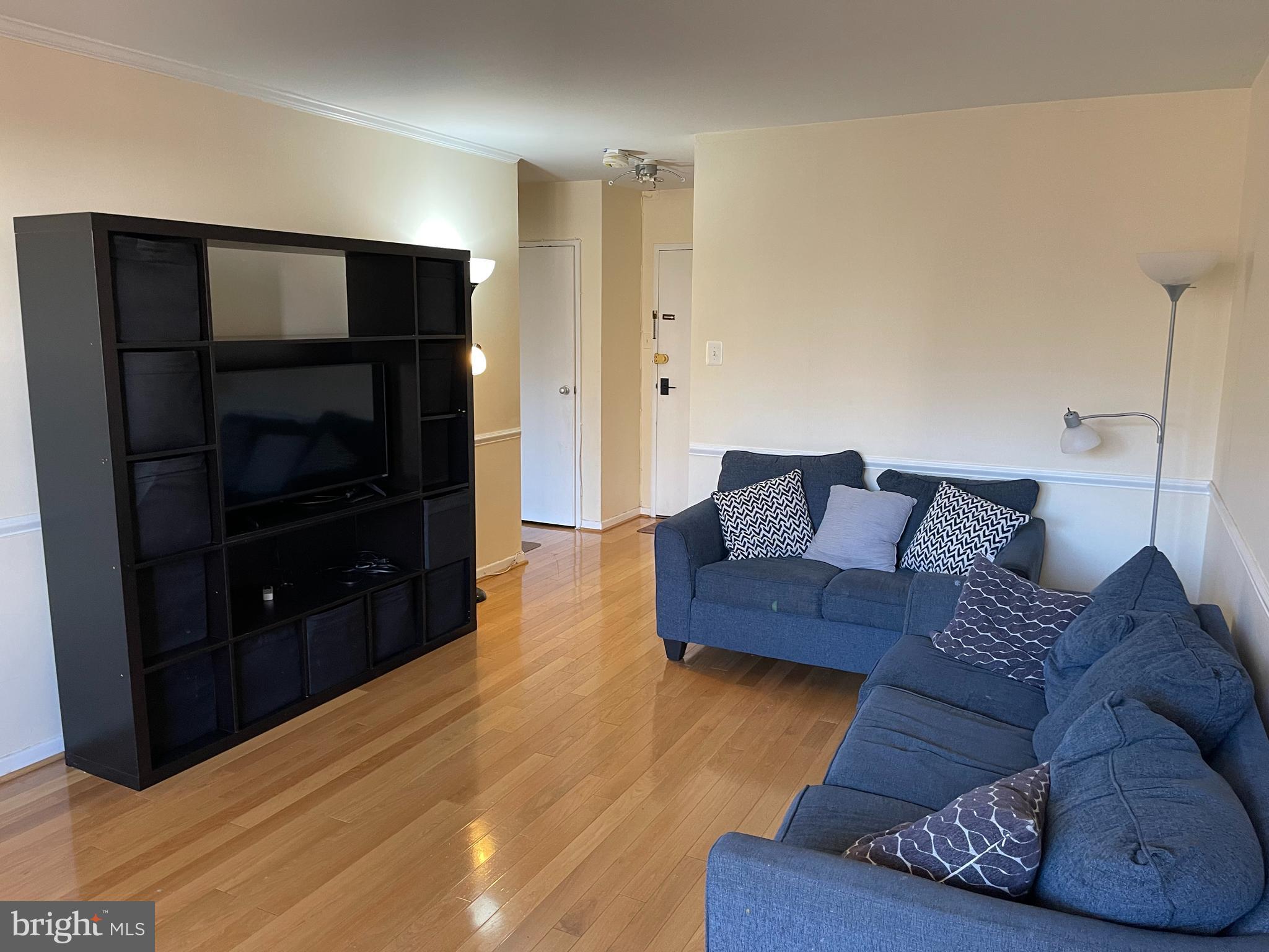 940 25th Street Northwest, Unit 317S Washington, DC 20037 - Photo 8 of 22 a living room with furniture and a flat screen tv