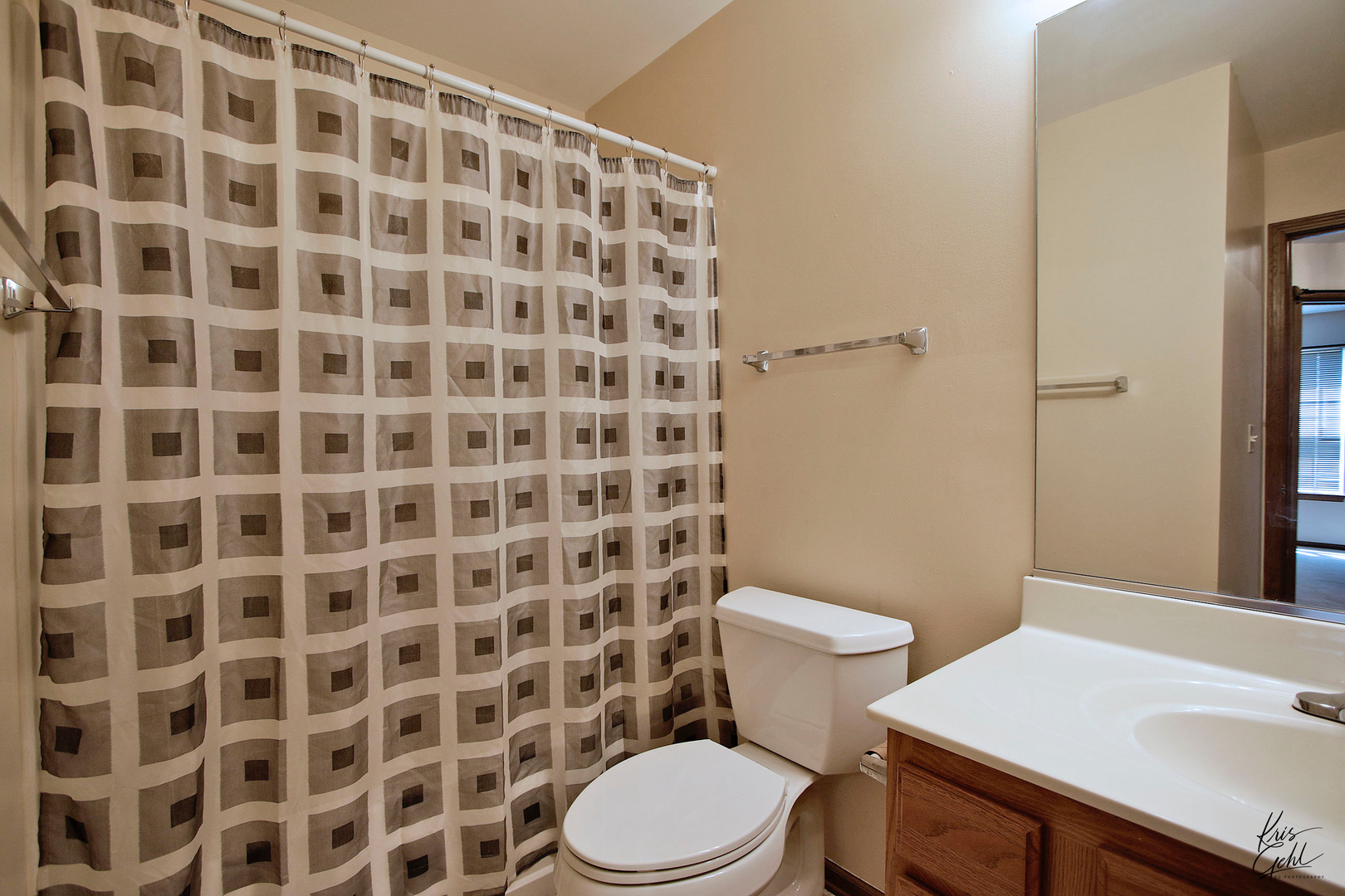 571 Willow Way Lindenhurst, IL 60046 - Photo 14 of 22 a white toilet sitting next to a shower curtain