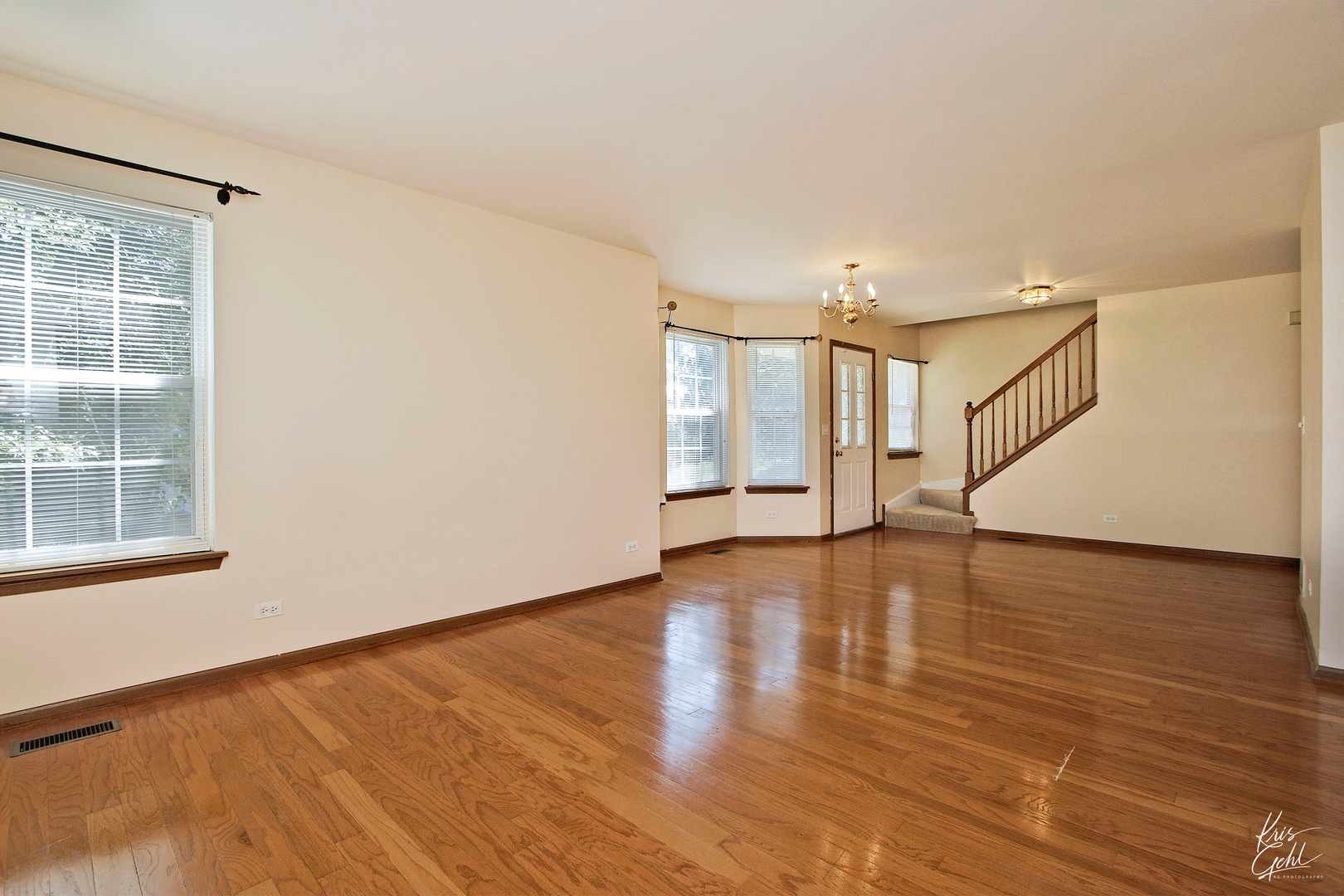 571 Willow Way Lindenhurst, IL 60046 - Photo 7 of 22 a view of an empty room with wooden floor and a window