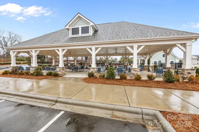 a view of a swimming pool with outdoor seating