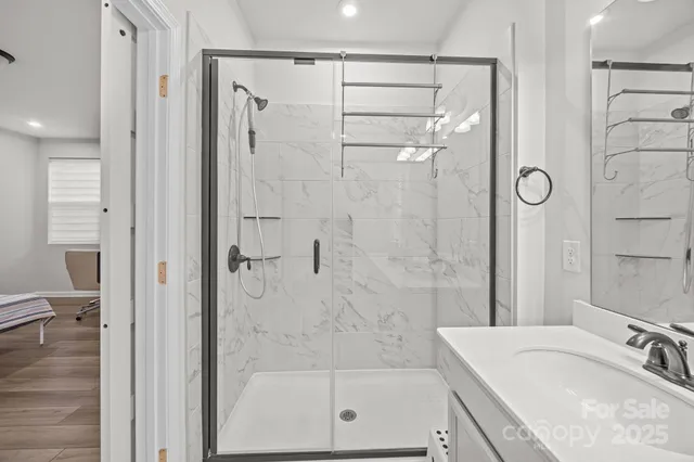 a bathroom with a granite countertop bathtub shower sink and toilet