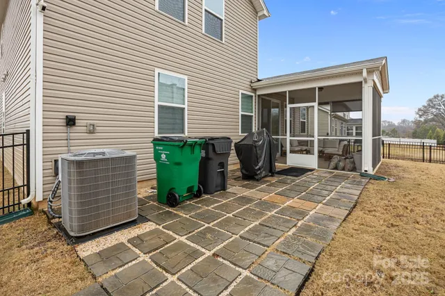 a view of a house with backyard and a patio