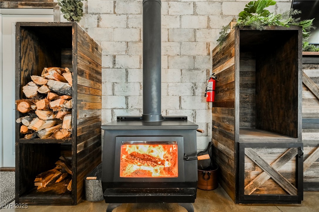 6510 Sunset Drive Caliente, NV 89008 - Photo 11 of 84 Detailed view of a wood stove and a fire extinguisher