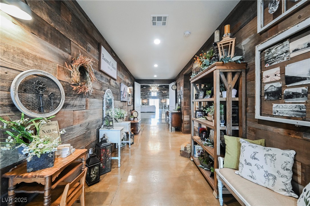 6510 Sunset Drive Caliente, NV 89008 - Photo 16 of 84 Hall with wooden walls, finished concrete floors, and recessed lighting