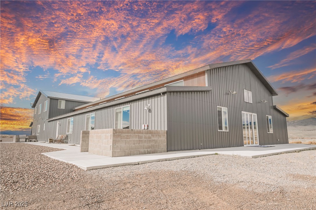 6510 Sunset Drive Caliente, NV 89008 - Photo 2 of 84 Property exterior at dusk with a patio area