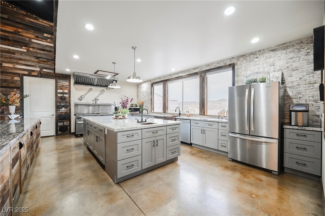 6510 Sunset Drive Caliente, NV 89008 - Photo 24 of 84 Kitchen with gray cabinets, stainless steel appliances, light stone countertops, finished concrete flooring, and recessed lighting