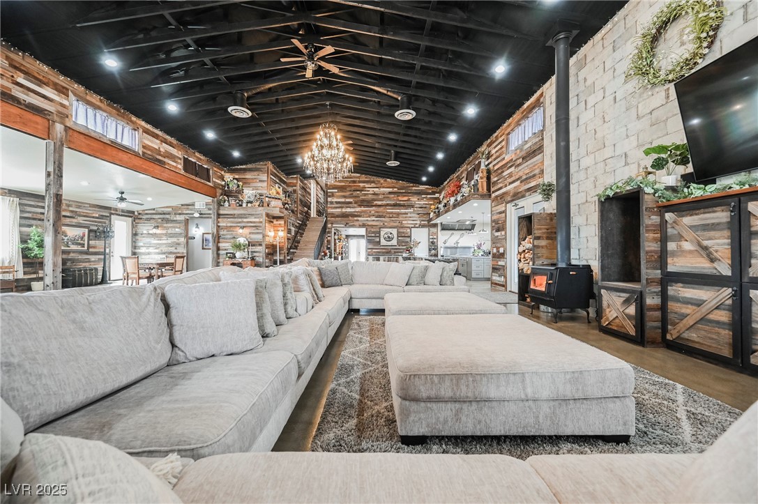 6510 Sunset Drive Caliente, NV 89008 - Photo 32 of 84 Living room featuring a wood stove, high vaulted ceiling, and a chandelier