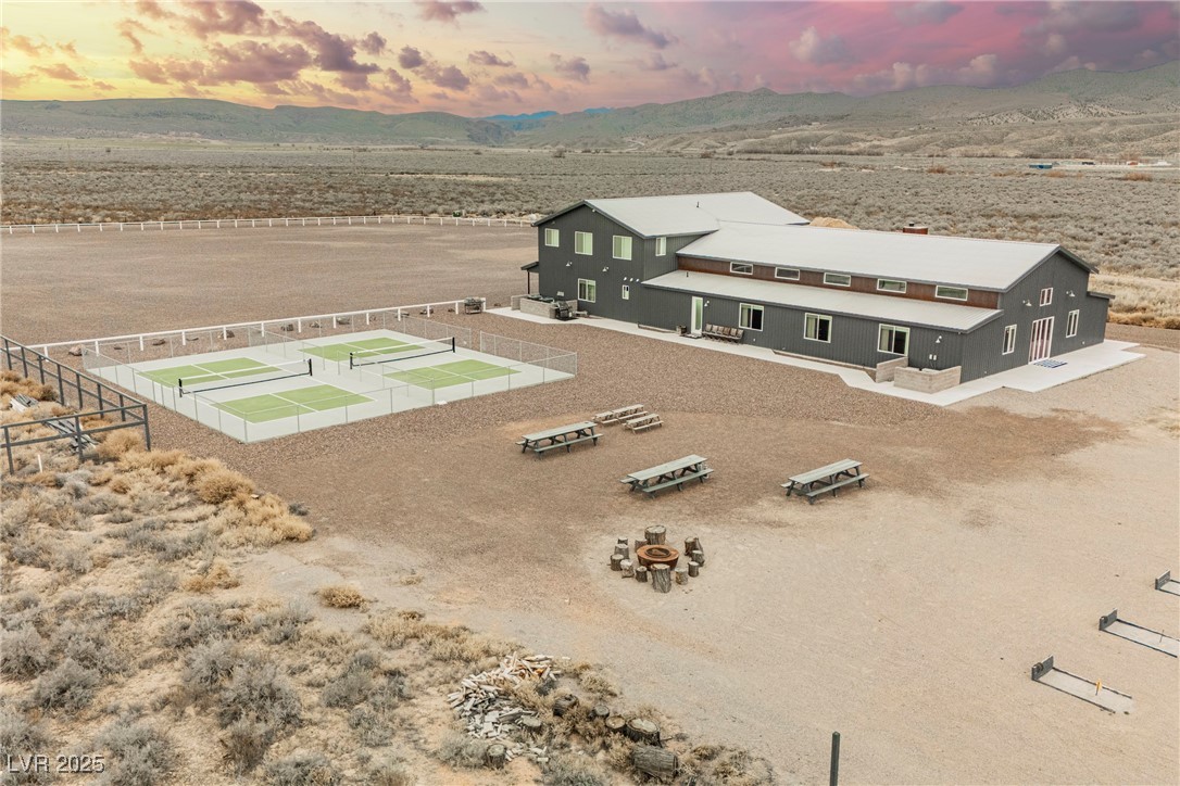 6510 Sunset Drive Caliente, NV 89008 - Photo 4 of 84 Aerial view of property and surrounding area with a mountainous background and a desert landscape