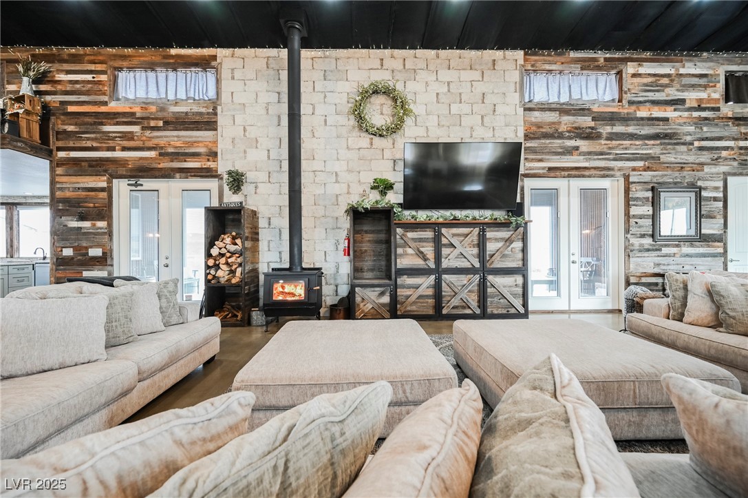 6510 Sunset Drive Caliente, NV 89008 - Photo 57 of 84 Living room with a wood stove, a high ceiling, and wood walls