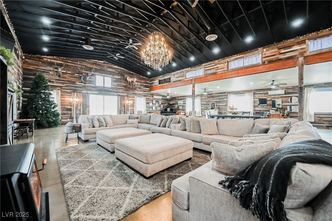 6510 Sunset Drive Caliente, NV 89008 - Photo 58 of 84 Living room with a ceiling fan, high vaulted ceiling, a chandelier, and concrete flooring