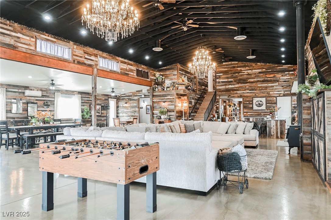 6510 Sunset Drive Caliente, NV 89008 - Photo 59 of 84 Game room featuring a chandelier, high vaulted ceiling, finished concrete floors, and a ceiling fan