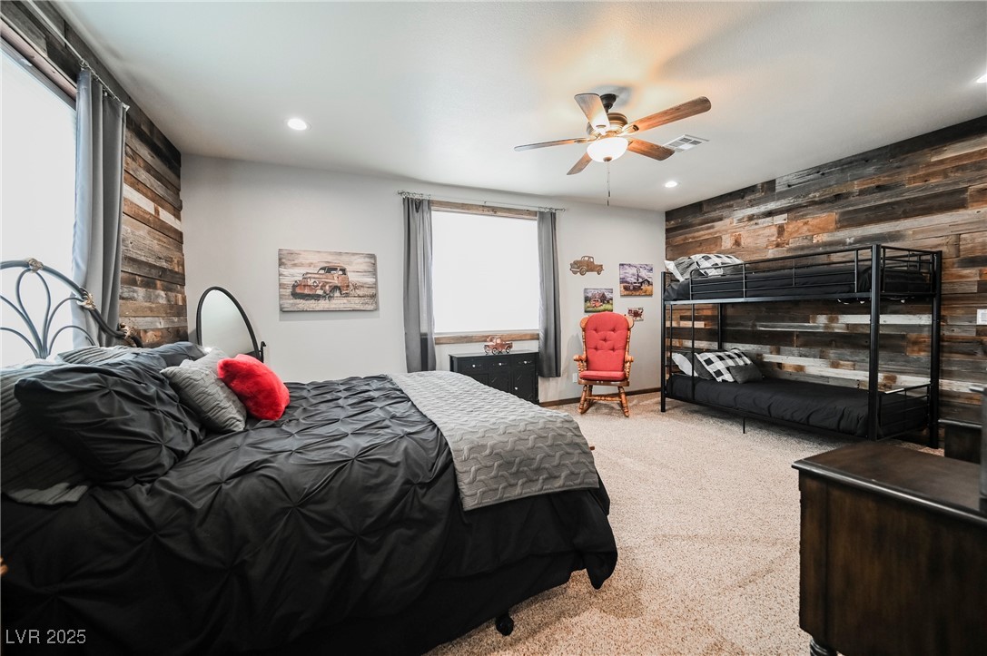 6510 Sunset Drive Caliente, NV 89008 - Photo 67 of 84 Carpeted bedroom with wooden walls, an accent wall, recessed lighting, and a ceiling fan