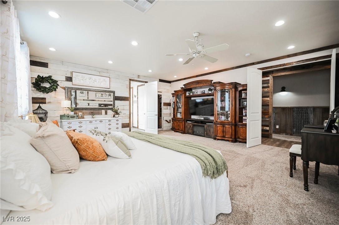 6510 Sunset Drive Caliente, NV 89008 - Photo 70 of 84 Bedroom featuring carpet floors, wood walls, recessed lighting, ceiling fan, and ornamental molding