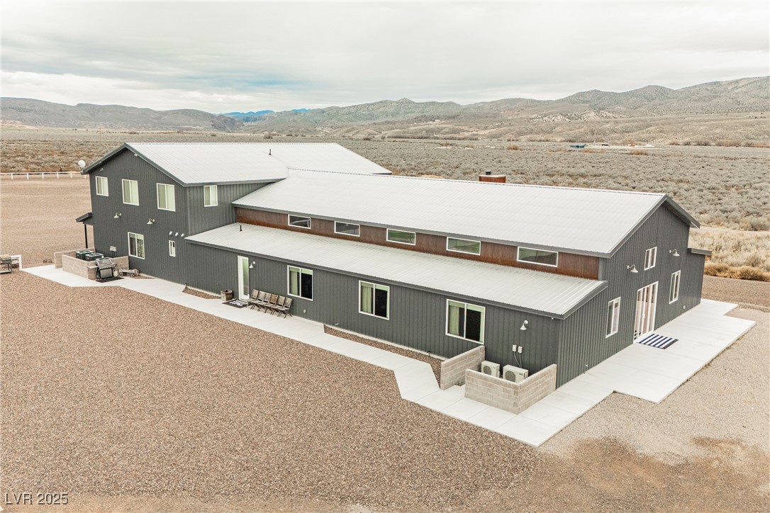 6510 Sunset Drive Caliente, NV 89008 - Photo 75 of 84 Rear view of house with a mountain view, a patio, and a metal roof