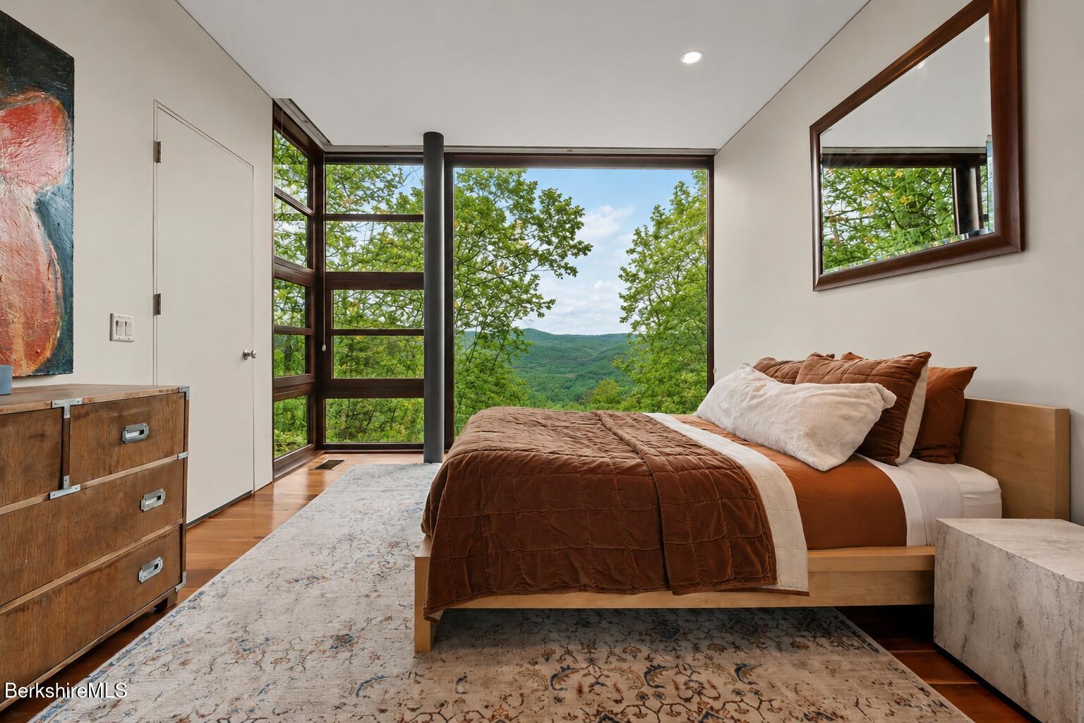 250 Long Pond Road Great Barrington, MA 01230 - Photo 49 of 56 a bedroom with a bed and large windows