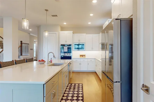 a large kitchen with a lot of counter space and refrigerator
