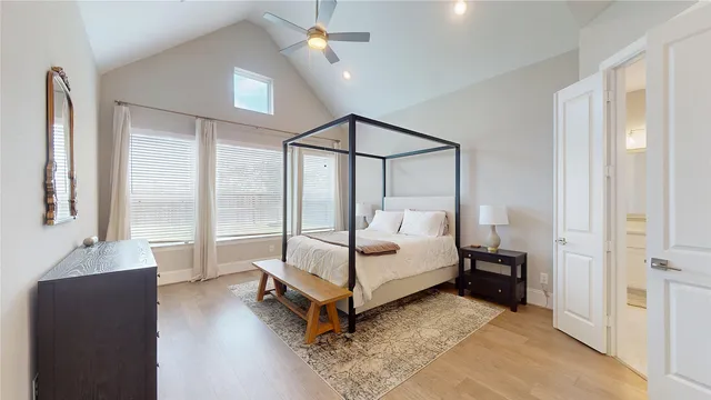 a spacious bedroom with a bed and a window