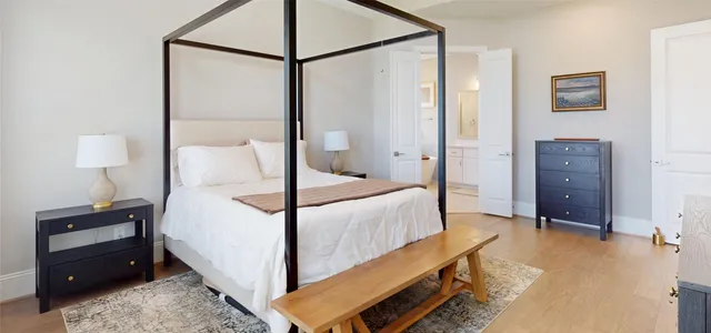 a bedroom with a bed and a night stand