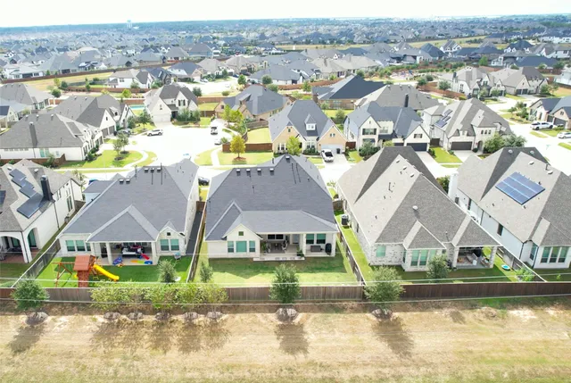 an aerial view of residential houses with outdoor space and river