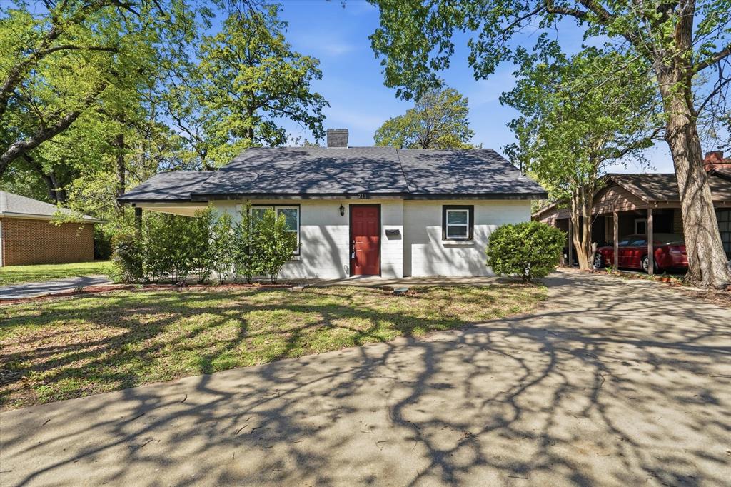 711 Roberts Cut Off Road River Oaks, TX 76114 - Photo 1 of 21 a front view of a house with a garden