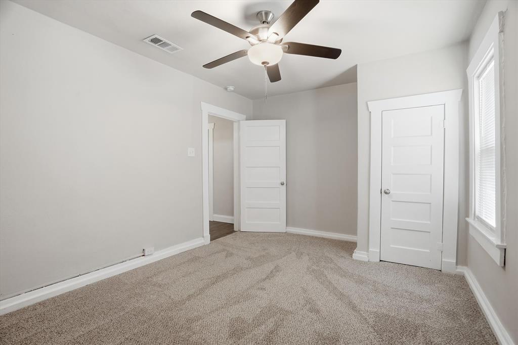 711 Roberts Cut Off Road River Oaks, TX 76114 - Photo 11 of 21 an empty room with fan and windows