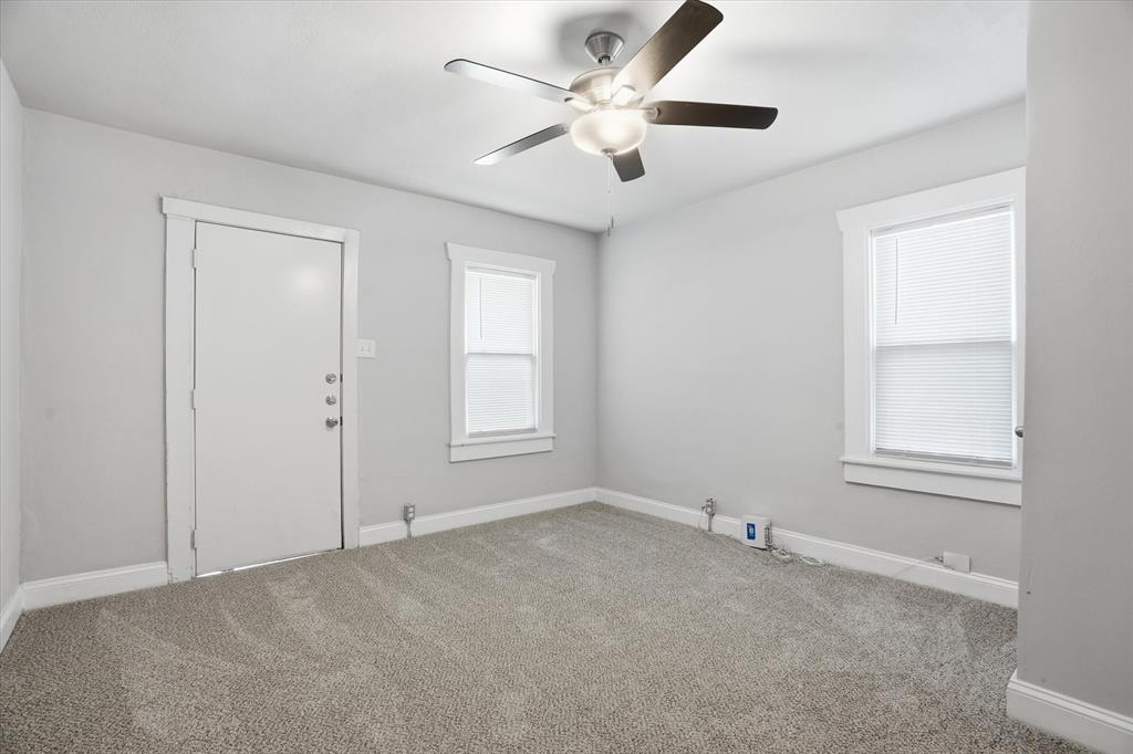 711 Roberts Cut Off Road River Oaks, TX 76114 - Photo 13 of 21 an empty room with chandelier fan and windows