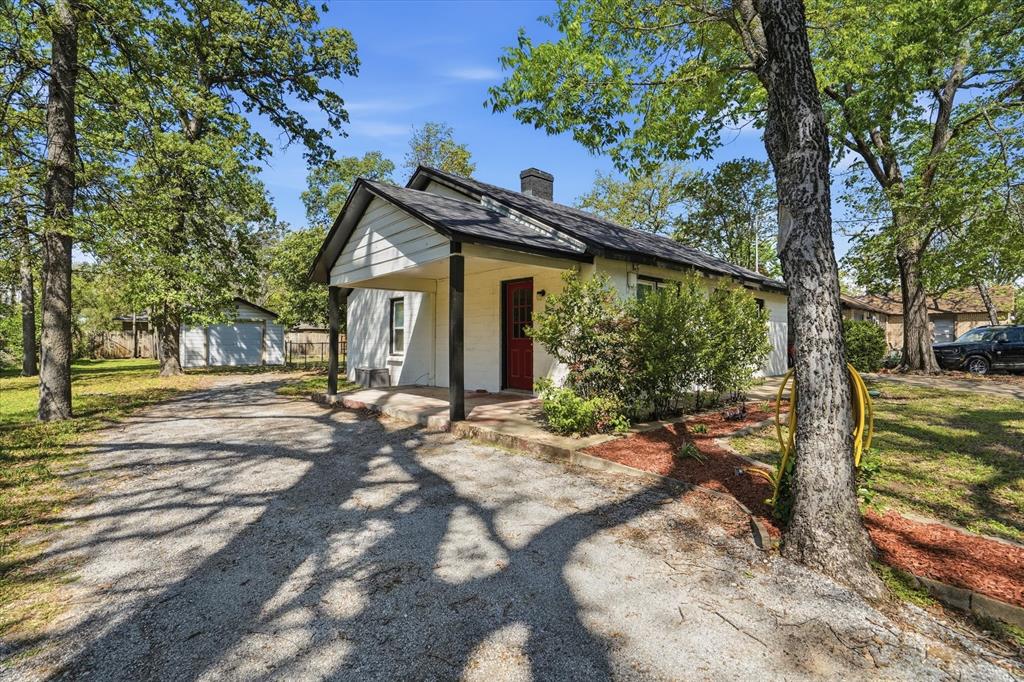 711 Roberts Cut Off Road River Oaks, TX 76114 - Photo 3 of 21 a view of a house with backyard and trees