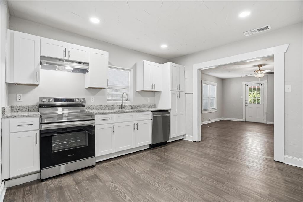 711 Roberts Cut Off Road River Oaks, TX 76114 - Photo 4 of 21 a kitchen with granite countertop a stove top oven and cabinets