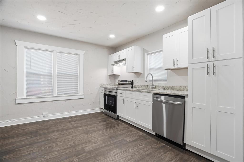 711 Roberts Cut Off Road River Oaks, TX 76114 - Photo 5 of 21 a kitchen with granite countertop white cabinets and white appliances