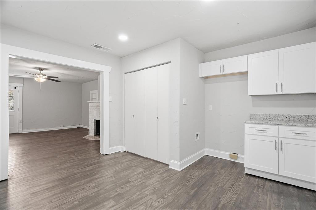711 Roberts Cut Off Road River Oaks, TX 76114 - Photo 6 of 21 an empty room with wooden floor and cabinet