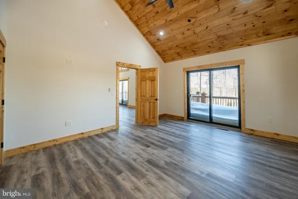 a bathroom with a granite countertop sink toilet and mirror