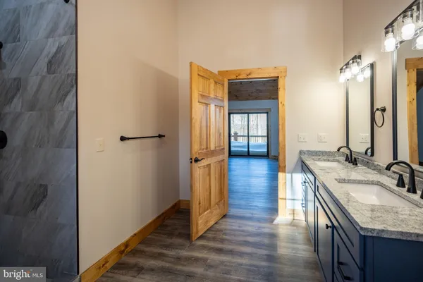 a bathroom with a granite countertop sink toilet and shower
