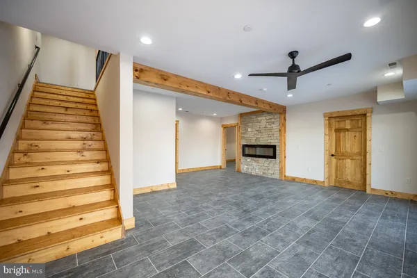 a bathroom with a bathtub shower sink vanity mirror and toilet