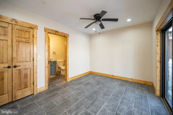 a view of empty room with wooden floor