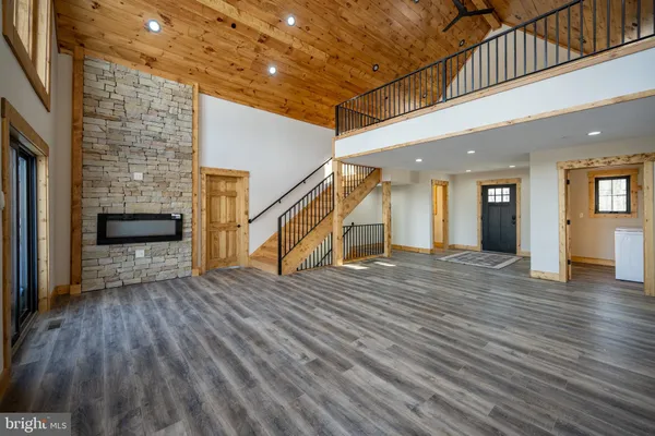 a large kitchen with stainless steel appliances granite countertop a large stove a sink dishwasher and a microwave oven with wooden floor