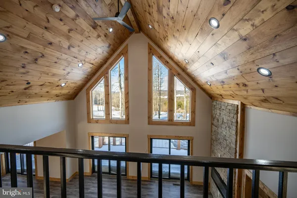 a view of a room with wooden floor and window