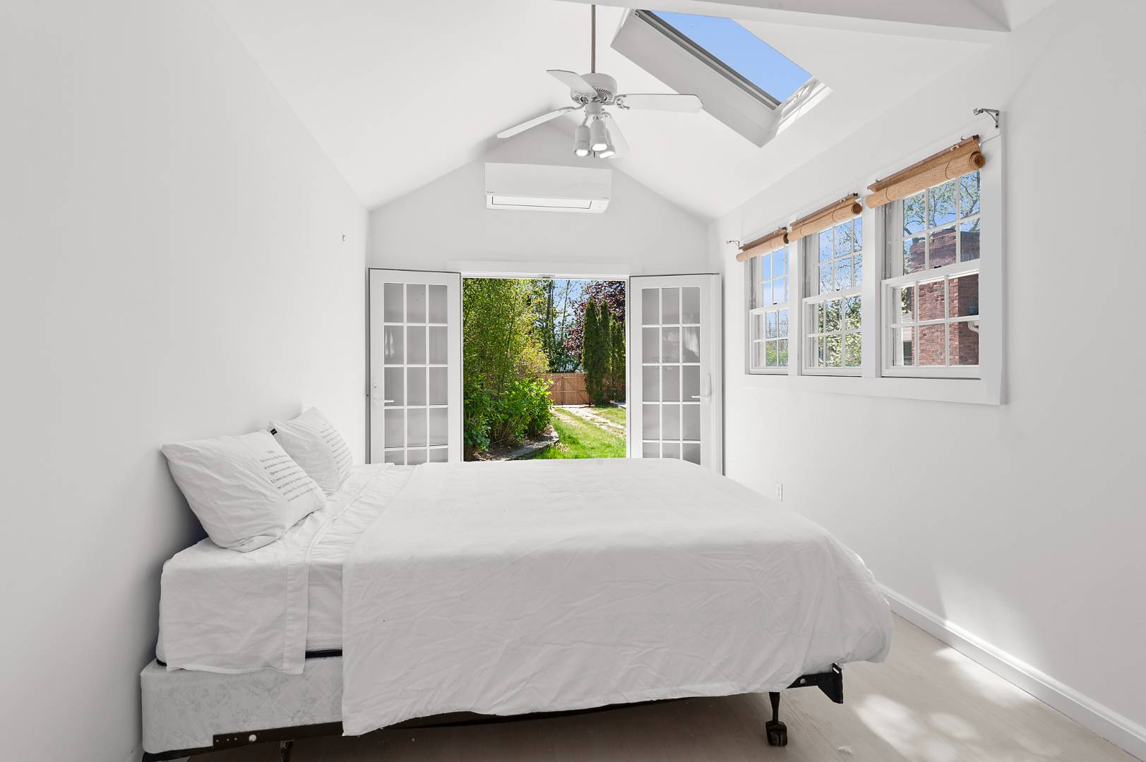 5 Willow Lane East Hampton, NY 11937 - Photo 9 of 9 a large bed sitting in a bedroom next to a window