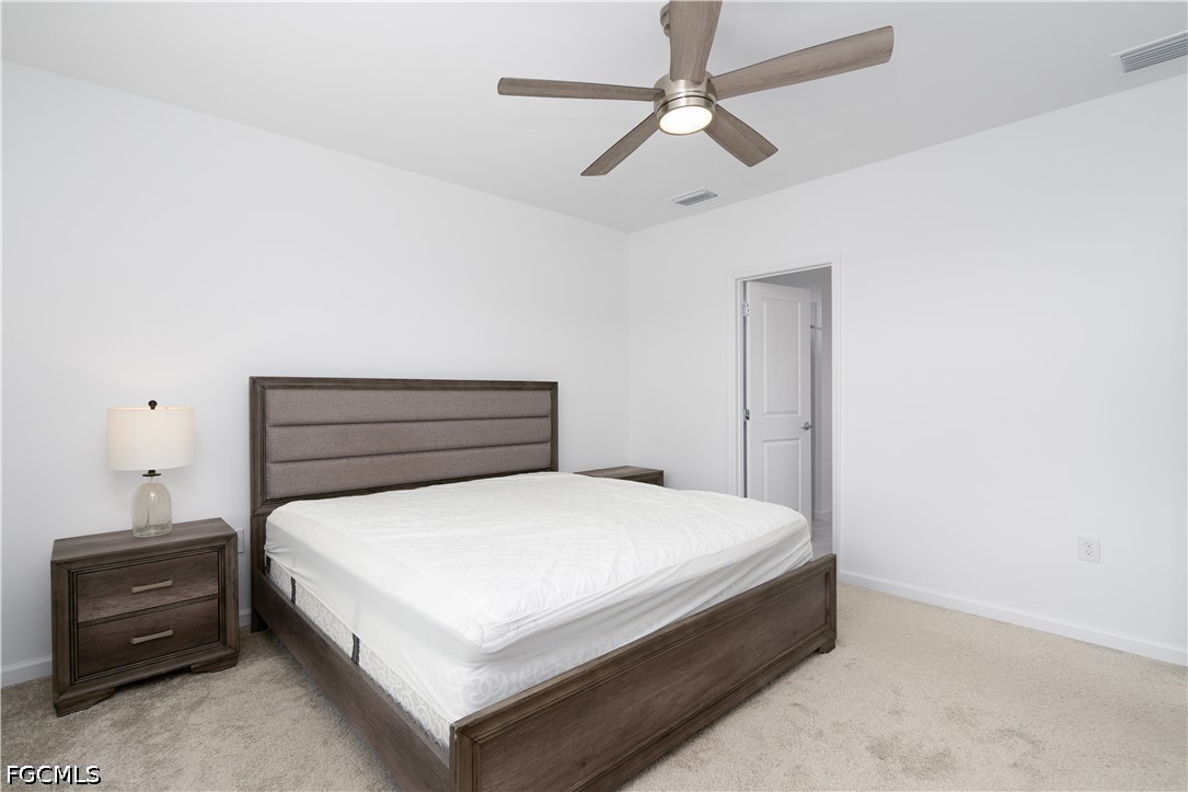 42428 Cascade Drive Punta Gorda, FL 33982 - Photo 13 of 47 a bedroom with a bed and a chandelier