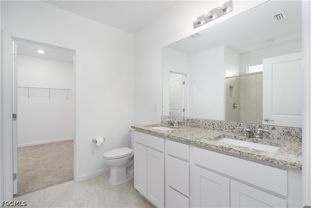 42428 Cascade Drive Punta Gorda, FL 33982 - Photo 14 of 47 a spacious bathroom with a granite countertop sink a toilet and a mirror