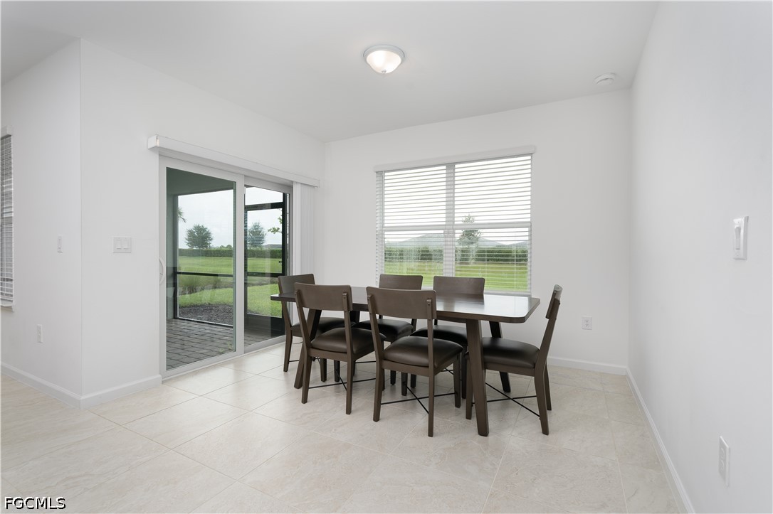 42428 Cascade Drive Punta Gorda, FL 33982 - Photo 8 of 47 a dining room with furniture and a floor to ceiling window