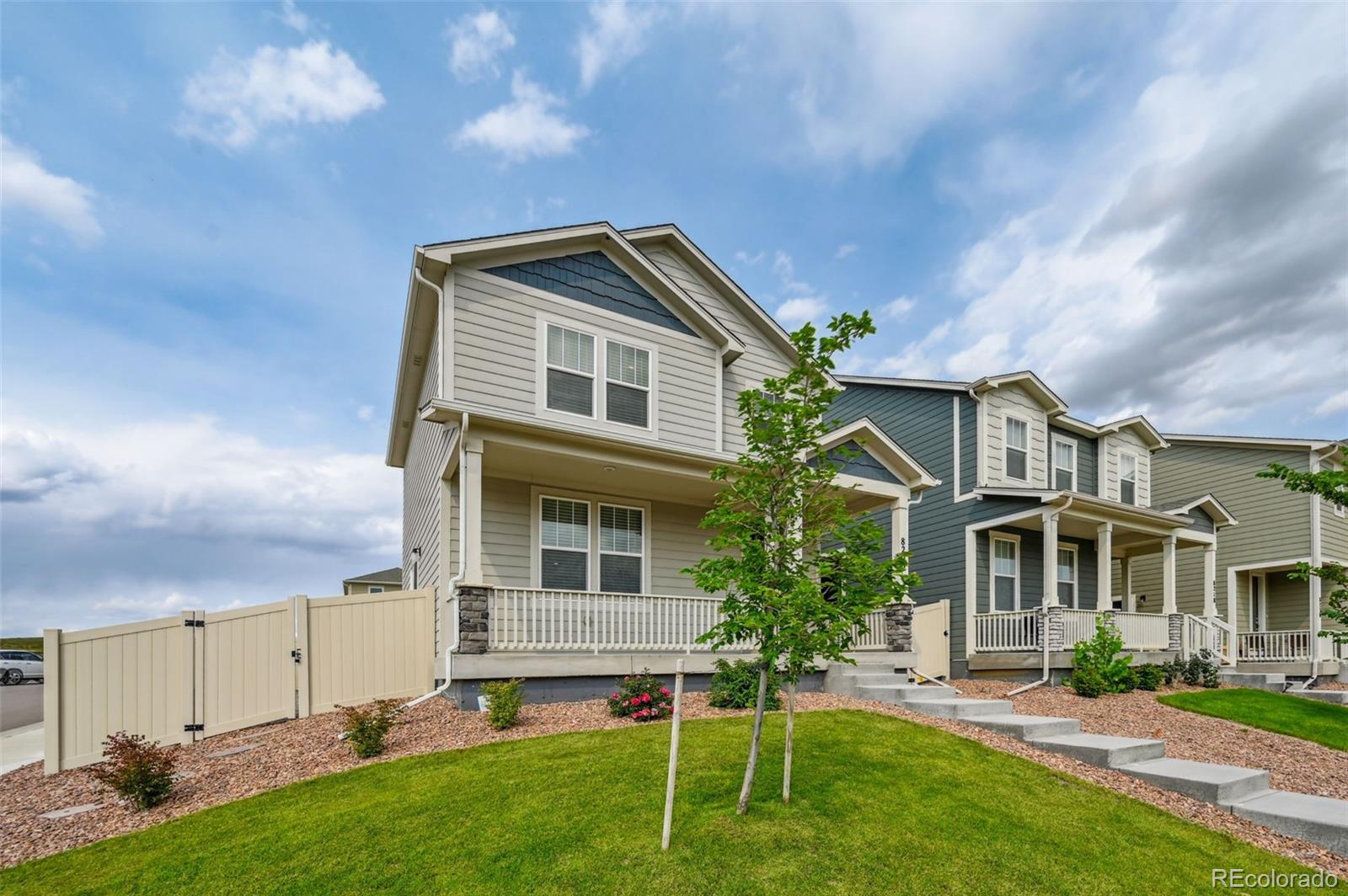 8206 Turtle Lake Way Colorado Springs, CO 80925 - Photo 1 of 27 a front view of a house with a yard and trees