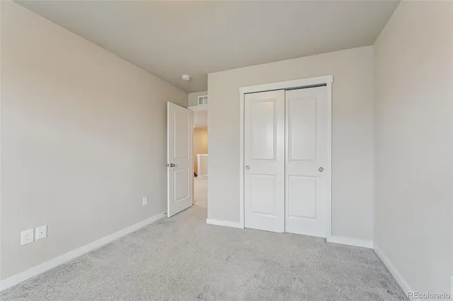 a view of an empty room and closet area