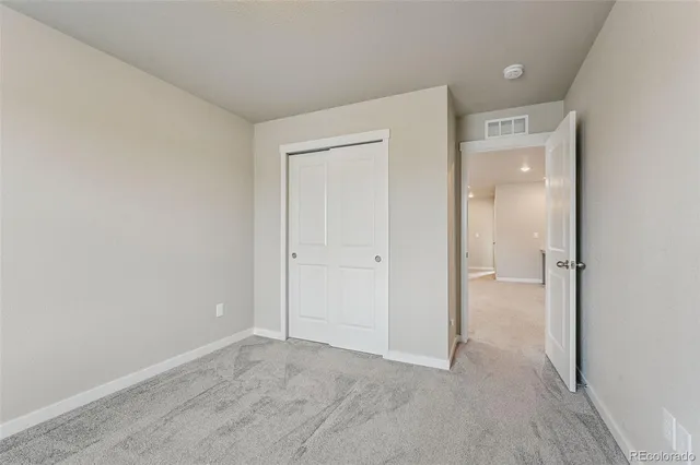 a view of an empty room and closet area