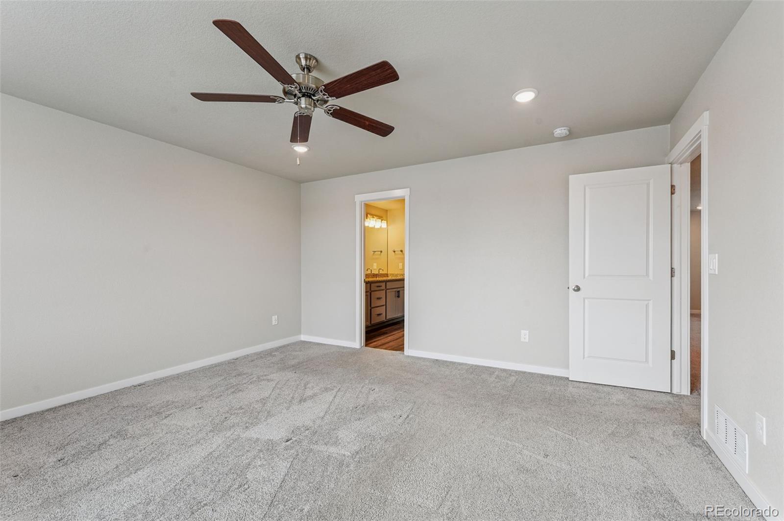 8206 Turtle Lake Way Colorado Springs, CO 80925 - Photo 20 of 27 a view of an empty room with ceiling fan