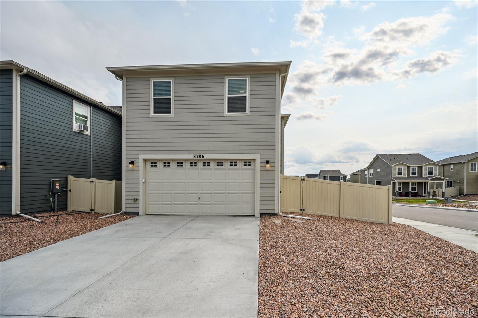 8206 Turtle Lake Way Colorado Springs, CO 80925 - Photo 27 of 27 a view of a house with a yard