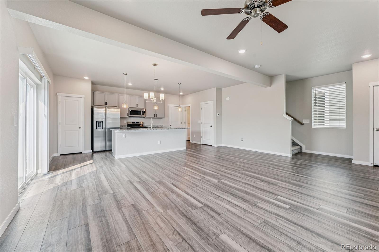 8206 Turtle Lake Way Colorado Springs, CO 80925 - Photo 5 of 27 a view of a kitchen with a dishwasher cabinets and wooden floor