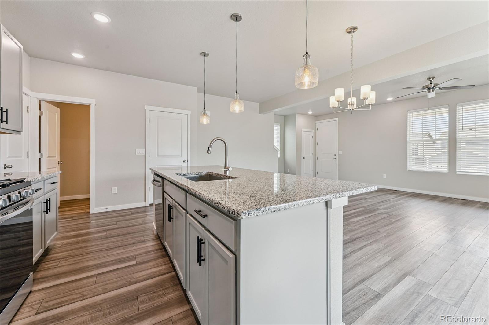 8206 Turtle Lake Way Colorado Springs, CO 80925 - Photo 8 of 27 a kitchen with a stove and wooden floor