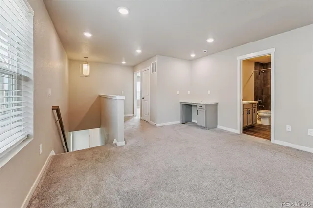 a view of a hallway with seating area