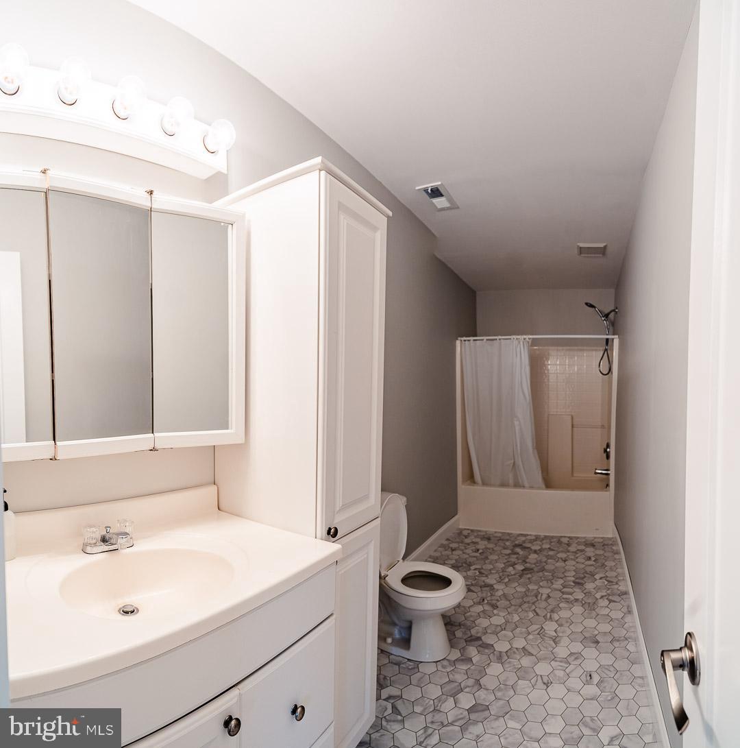 6825 Briscoe Turn Road Owings, MD 20736 - Photo 27 of 47 a bathroom with a sink a toilet and shower